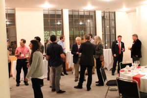 Attendees mingling at lecture reception.