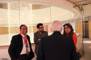 Attendees mingling at lecture reception.